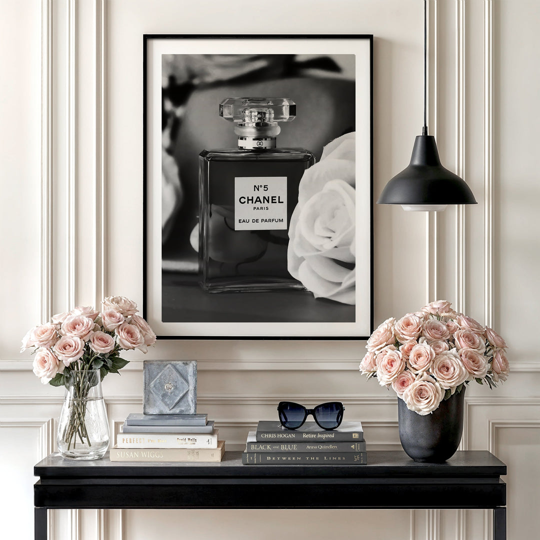 Luxury wall art with a black and white perfume bottle and a white rose in an elegant interior.
