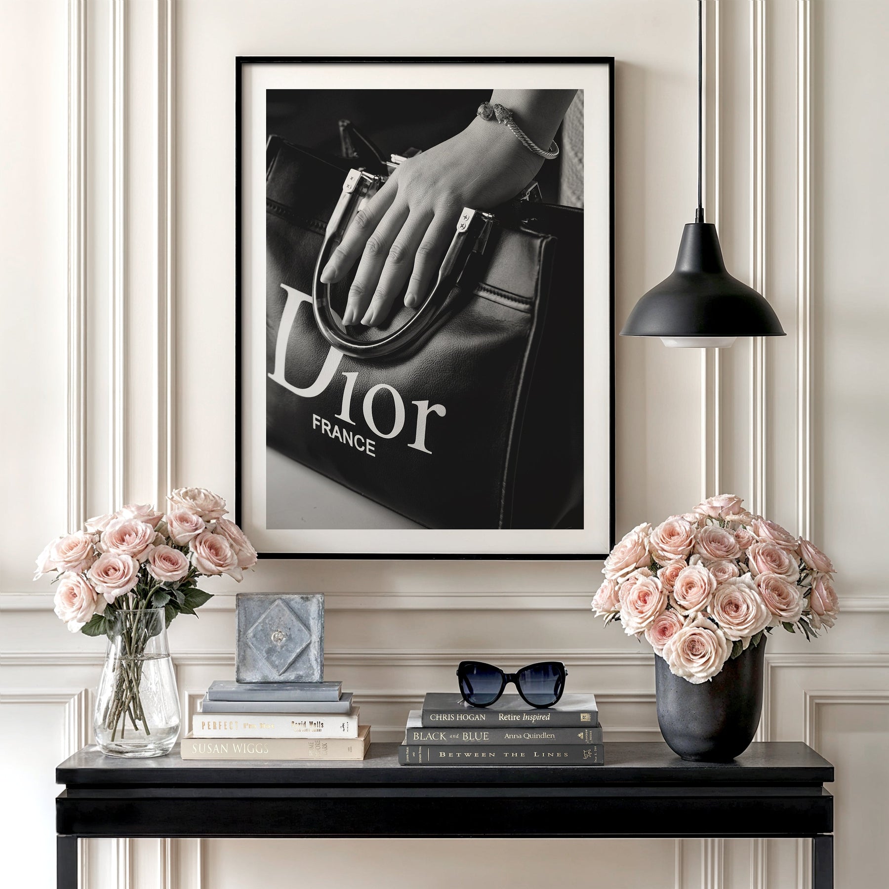 Luxury wall art with a black and white photograph of a Dior handbag in hand in a minimalist interior, fashion decor