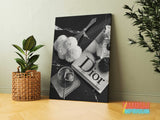 Luxury Dior canvas wall art in a black and white composition with flowers, perfume and a candle in a modern interior.