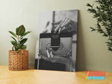Motivational canvas print with a black and white photograph of a Prada handbag in a modern interior