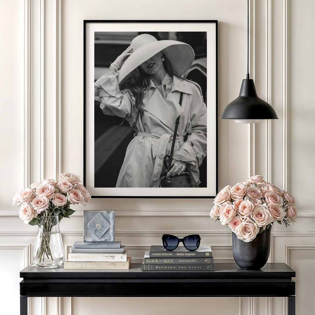 Luxury canvas print with a black and white elegant woman in a hat hanging above a dresser with roses