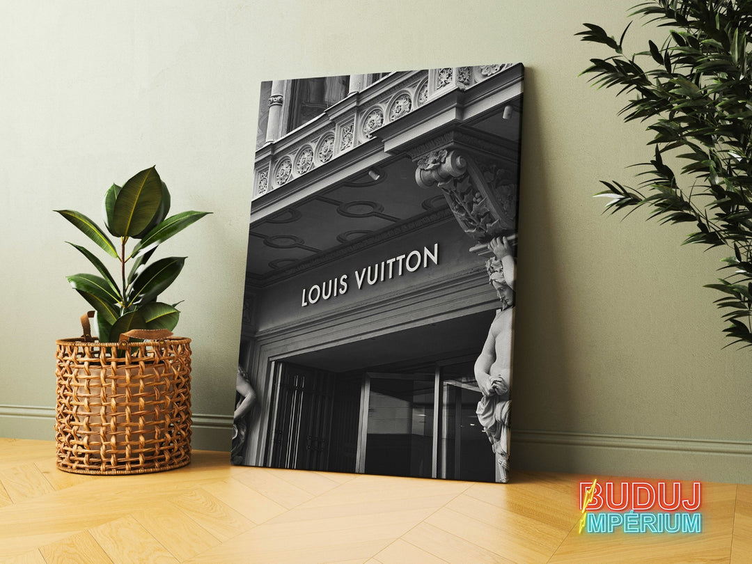 Modern canvas print with the black and white facade of a Louis Vuitton boutique and statues in an urban pop art style