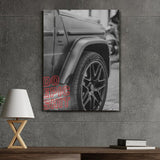 Motivational canvas wall art with a luxury SUV wheel detail and red Do Epic Shit text in a modern office.