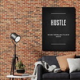 HUSTLE motivational wall art with a quote in an industrial interior with a brick wall, sofa and floor lamp.