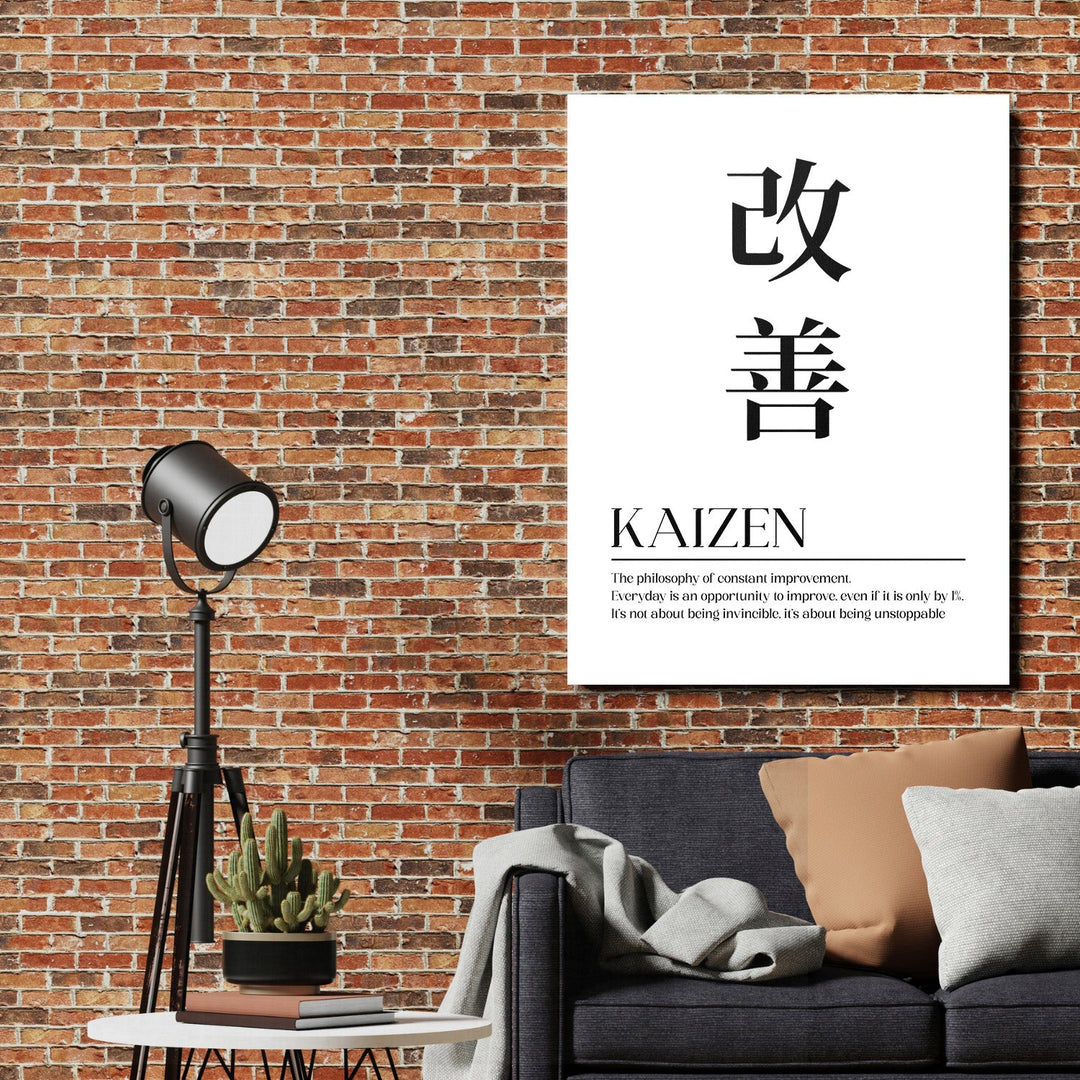 Kaizen motivational canvas wall art with a Japanese quote on a brick wall in a living room beside a lamp and sofa