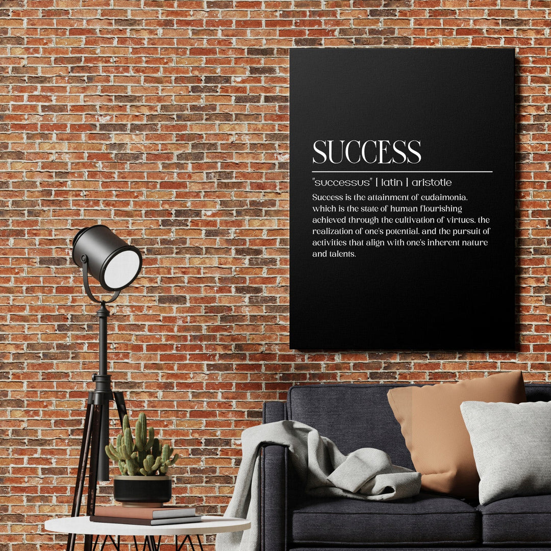 Motivational canvas print with the word SUCCESS on a black background in an industrial living room with a brick wall