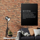 Motivational canvas print with the word SUCCESS on a black background in an industrial living room with a brick wall