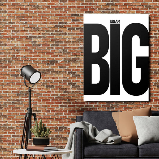 DREAM BIG motivational canvas wall art in an industrial interior with a brick wall, lamp and sofa
