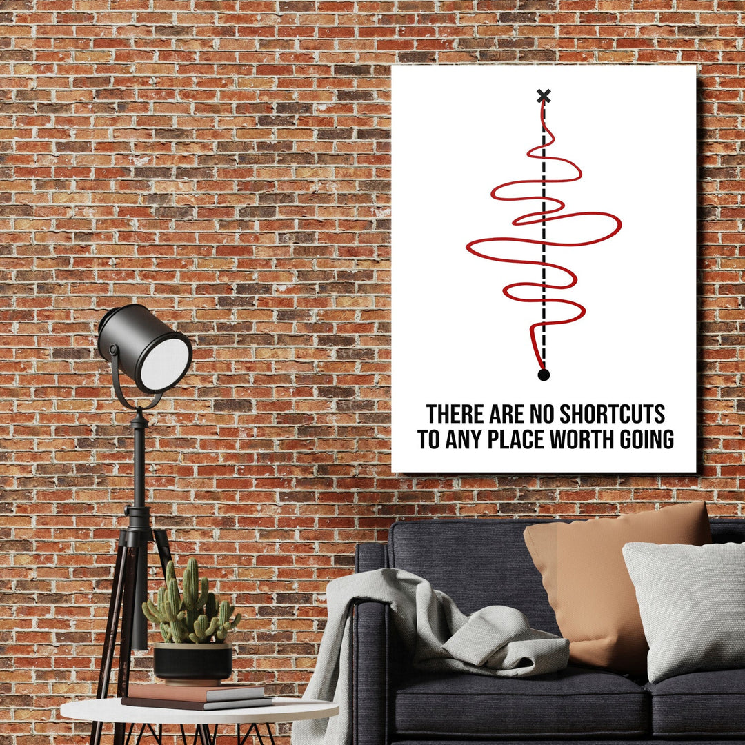 Motivational canvas print with a red spiral and quote on a brick wall in a living room