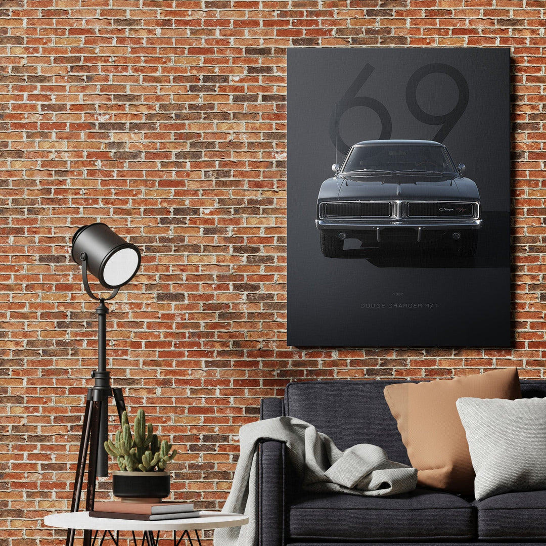Motivational canvas wall art with a dark Dodge Charger R/T and number 69 hanging above a sofa on a brick wall