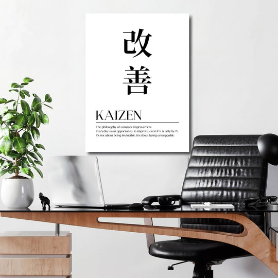 Kaizen motivational canvas wall art above a work desk and black chair in a modern office