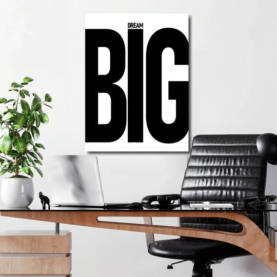 DREAM BIG black and white motivational canvas wall art hanging above a work desk in a minimalist office
