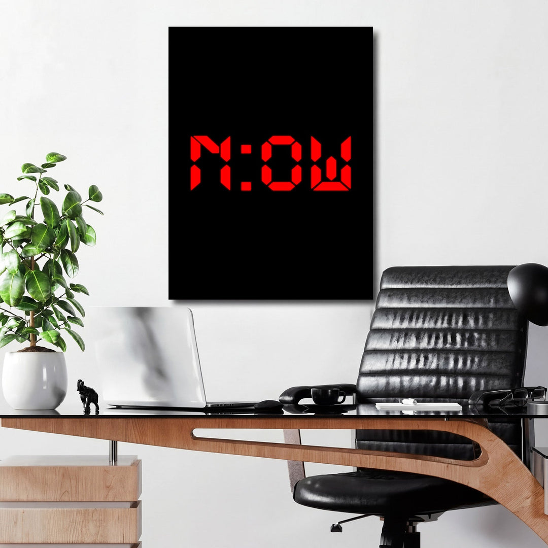 Motivational wall art with minimalist NOW lettering above a desk in a modern interior