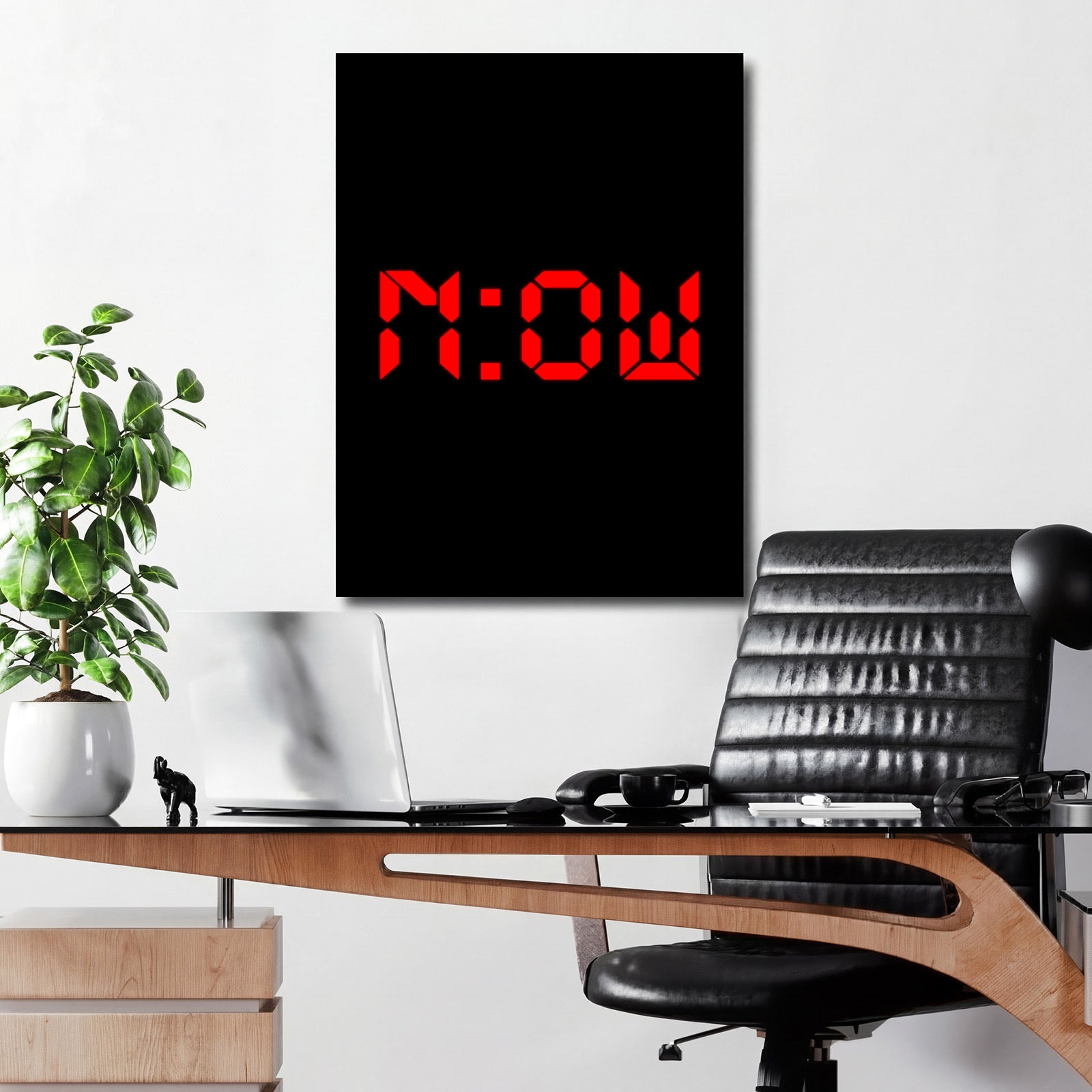 Motivational wall art with minimalist NOW lettering above a desk in a modern interior