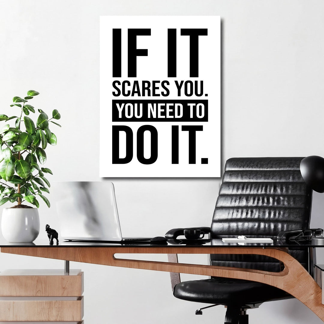 Front view of black and white minimalist motivational wall art with a quote in a modern office