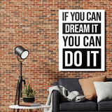 Black and white motivational quote wall art above a sofa beside a brick wall and floor lamp