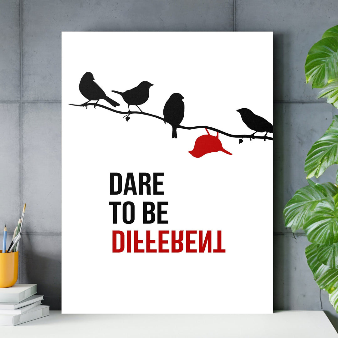 Motivational wall art with black birds on a branch and one red bird upside down, “Dare to be different” quote