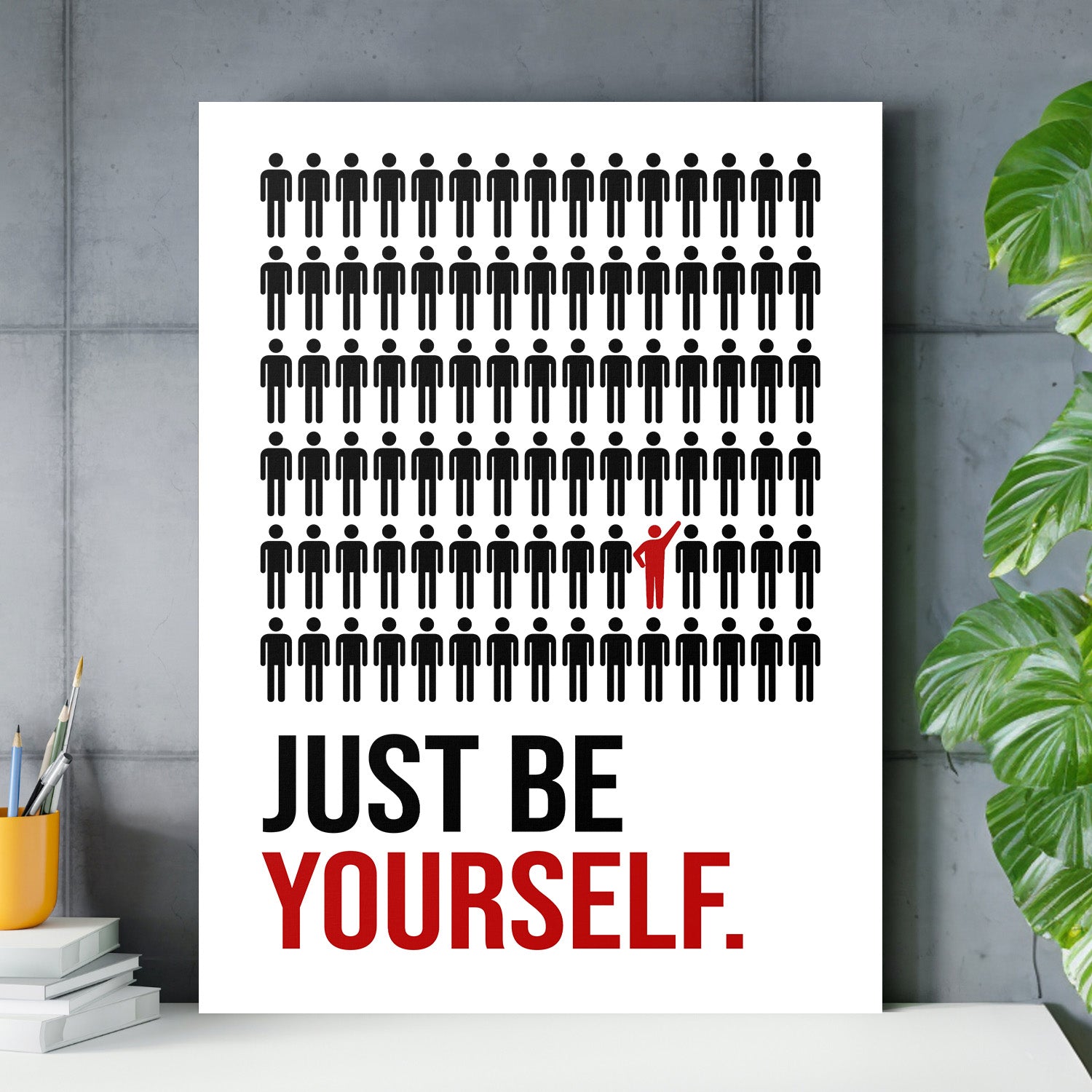 Motivational canvas wall art with black figures and one red figure above the “JUST BE YOURSELF” text