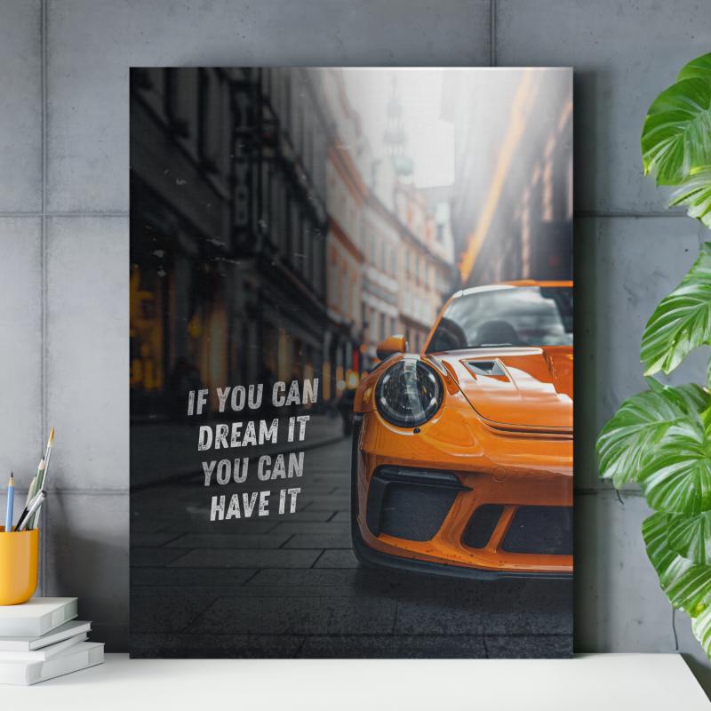 Motivational canvas wall art with an orange sports car on city pavement and an inspiring English quote.