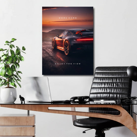 Motivational wall art with luxury sports car in a modern home office at a dramatic sunset