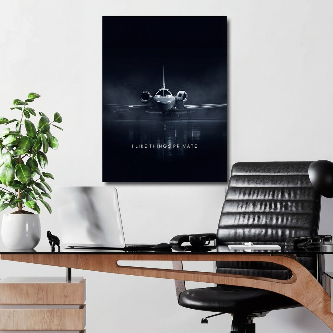 Motivational canvas print with a luxury private jet in an office, desk with laptop and plant