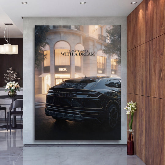 Motivational wall art with a black Lamborghini in front of a Dior boutique and the quote “It All Starts With a Dream” in a modern hall