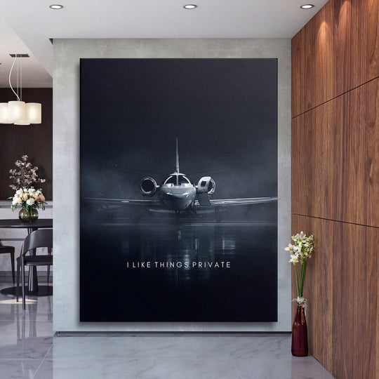 Motivational canvas print with a black-and-white private jet and text in a modern office, front view