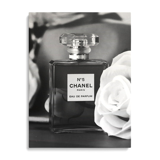 Chanel No. 5 modern canvas wall art displayed on a wall.