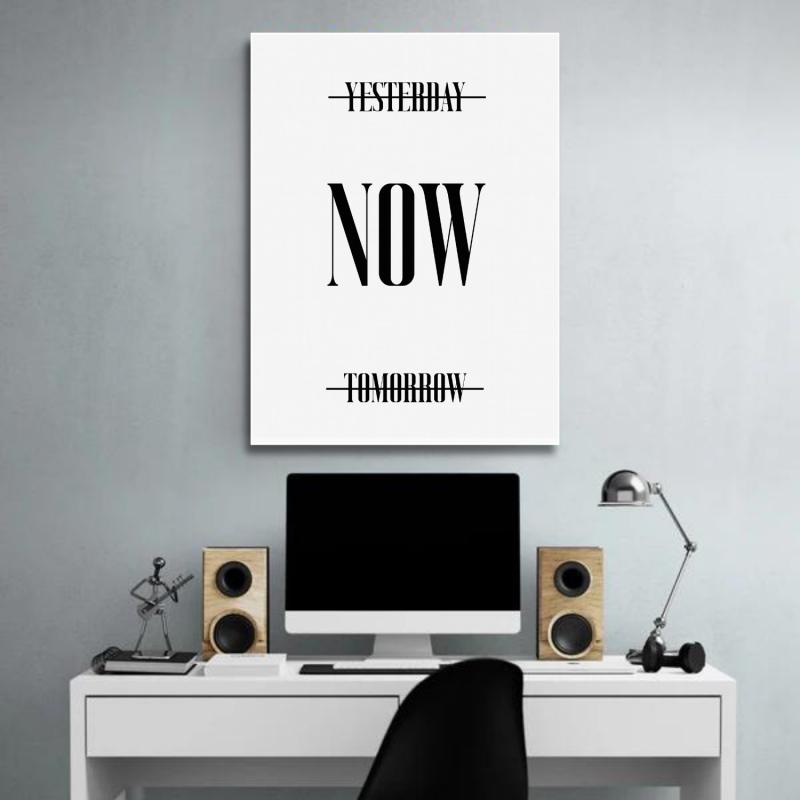 Motivational wall art for a modern office with a minimalist black-and-white “Now” quote above a desk.