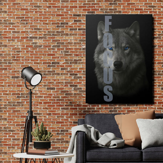Motivational canvas wall art with a wolf and FOCUS text hanging on a brick wall in a modern living room.