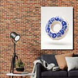 Modern canvas print with a blue-and-white porcelain motif above a sofa on a brick wall