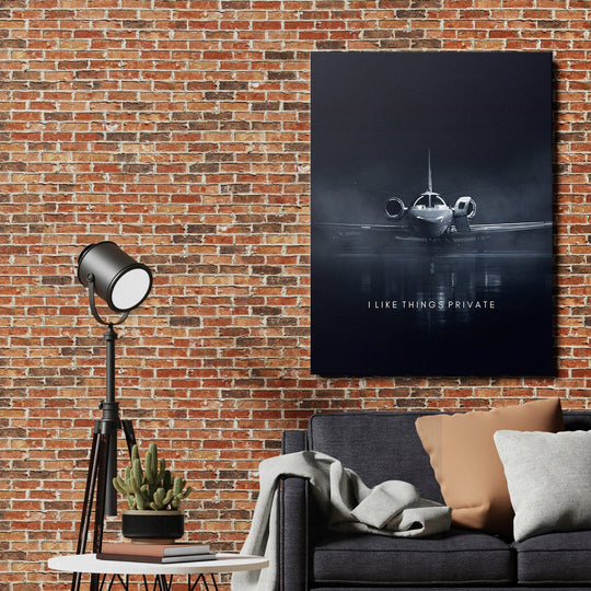 Motivational canvas print with a luxury private jet and the quote “I Like Things Private” in an industrial living room