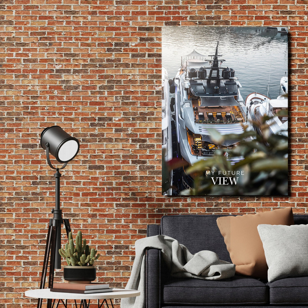 Motivational wall art with a luxury yacht and the text “My Future View” above a modern sofa in a living room