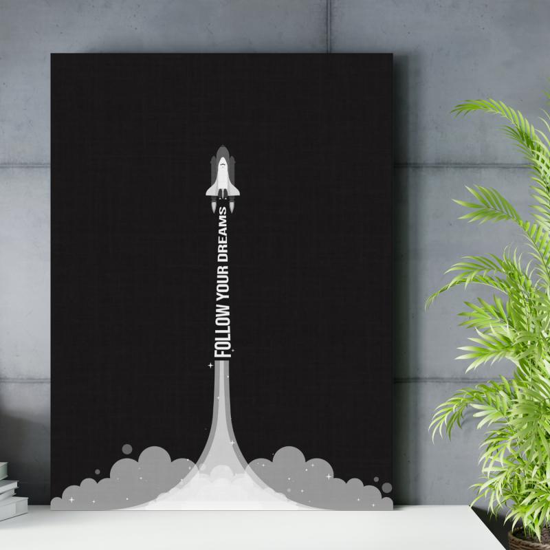 Motivational wall art with a minimalist rocket and “Follow Your Dreams” quote in a modern office.
