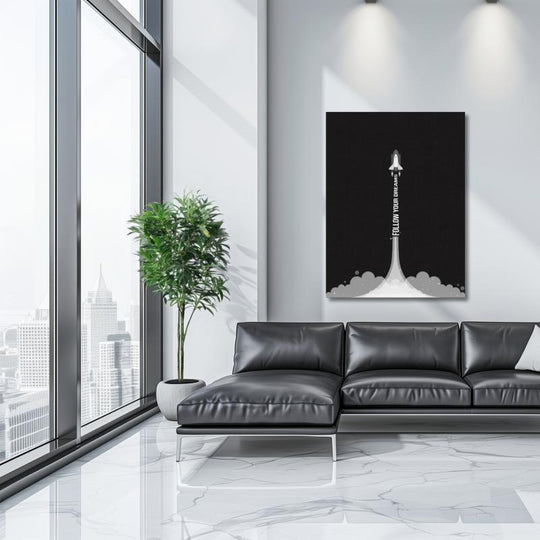 Motivational canvas wall art with a minimalist rocket in a modern living room with a black sofa.