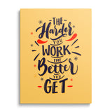 Motivational canvas print with the quote “The harder you work the better you get” on a yellow background, front view