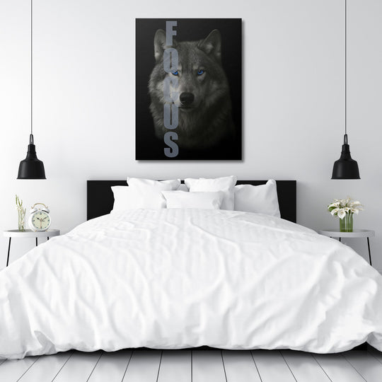 Motivational canvas wall art with a realistic wolf and FOCUS text in a modern minimalist bedroom.