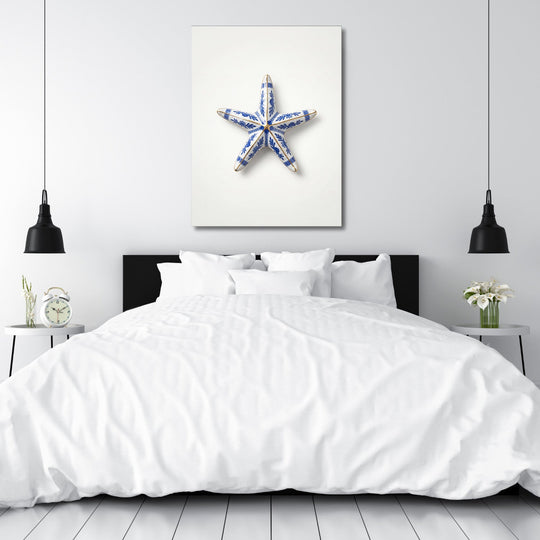 Modern wall art in a bedroom with a blue-and-white ceramic starfish and clean minimalist design