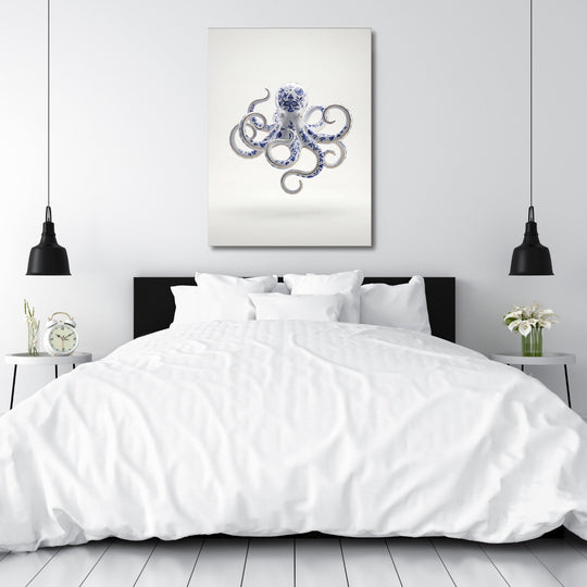 Modern canvas print with a blue-and-white porcelain octopus above a bed in a minimalist bedroom