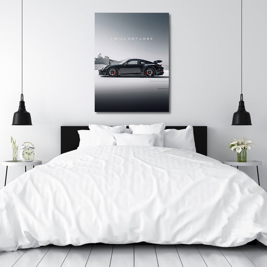 Motivational canvas wall art with black sports car and text I WILL NOT LOSE hanging in a white bedroom above the bed