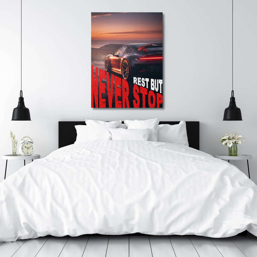 Motivational canvas print with a sports car at sunset and the text “Rest but Never Stop”, automotive lifestyle