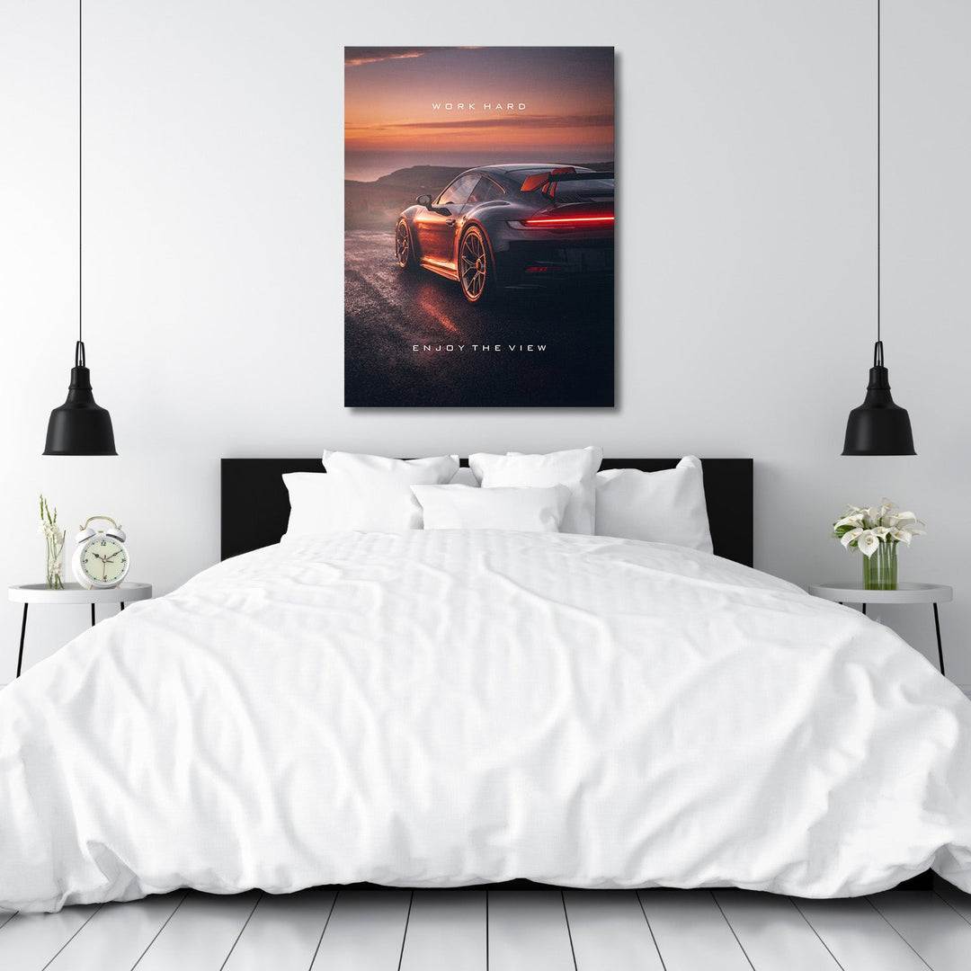 Motivational canvas wall art with black sports car at sunset above the bed in a modern bedroom