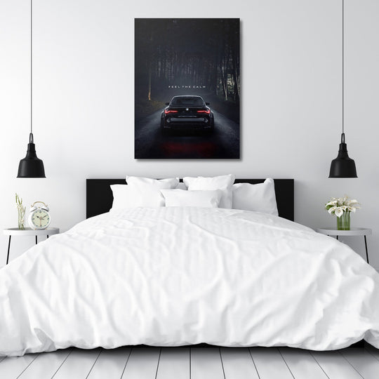 Motivational canvas print above a bed with a black BMW on a night road in a dark forest, automotive lifestyle