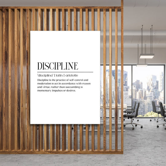 DISCIPLINE motivational canvas wall art with an Aristotle definition hanging in a modern office by a wooden partition