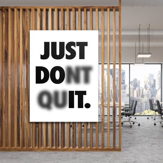 Just Don't Quit motivational canvas wall art with minimalist typography in a modern office behind a wooden partition