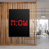 Motivational canvas print with red NOW lettering on a black background in a modern office