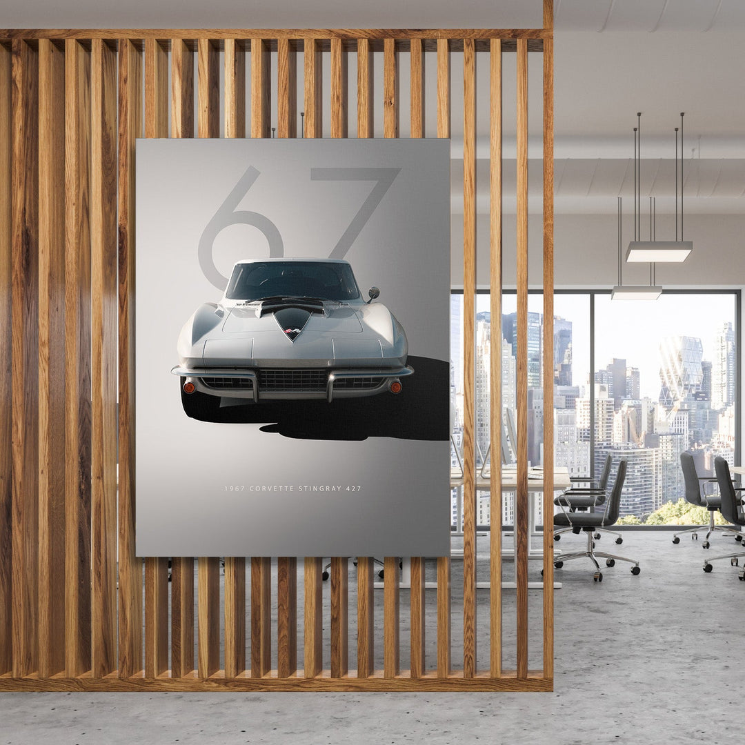 Motivational canvas wall art with a silver 1967 Corvette in a modern office overlooking a city skyline