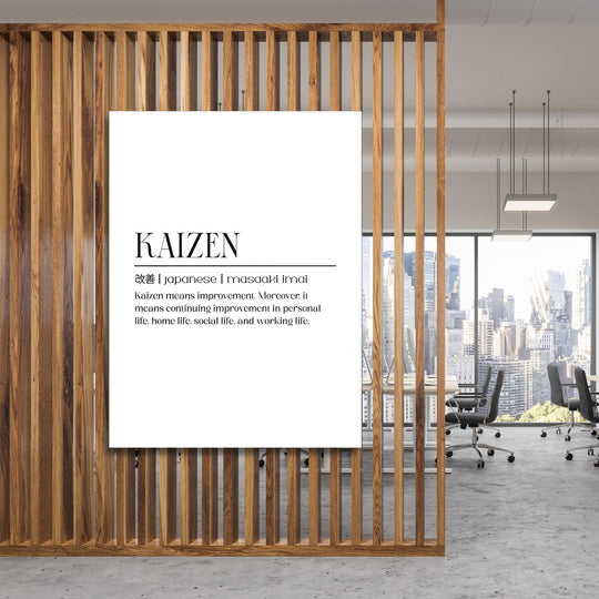 Kaizen motivational canvas wall art hanging on a wooden partition in an office with a city skyline view