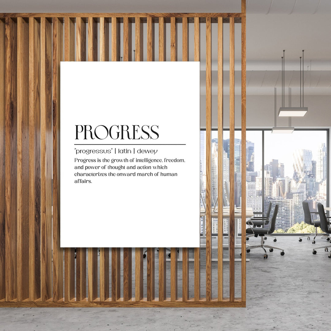 Motivational canvas print with a Progress quote hanging on a wooden partition in a modern office with a city view