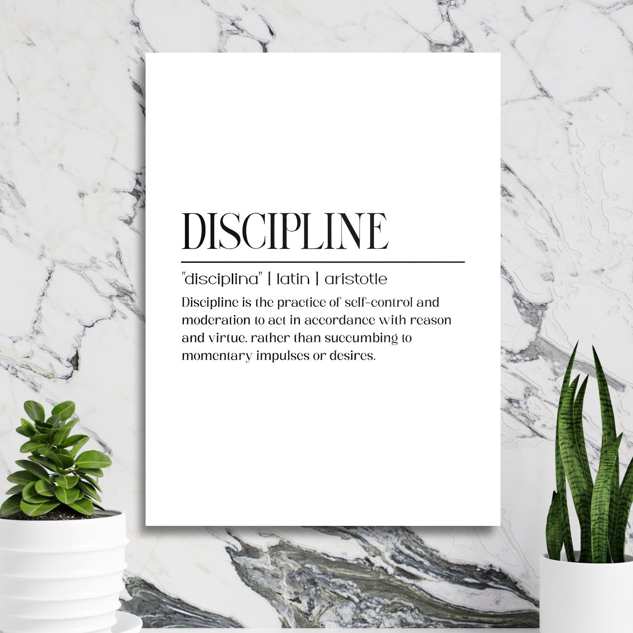 DISCIPLINE black and white motivational wall art on a marble wall near a work corner with plants